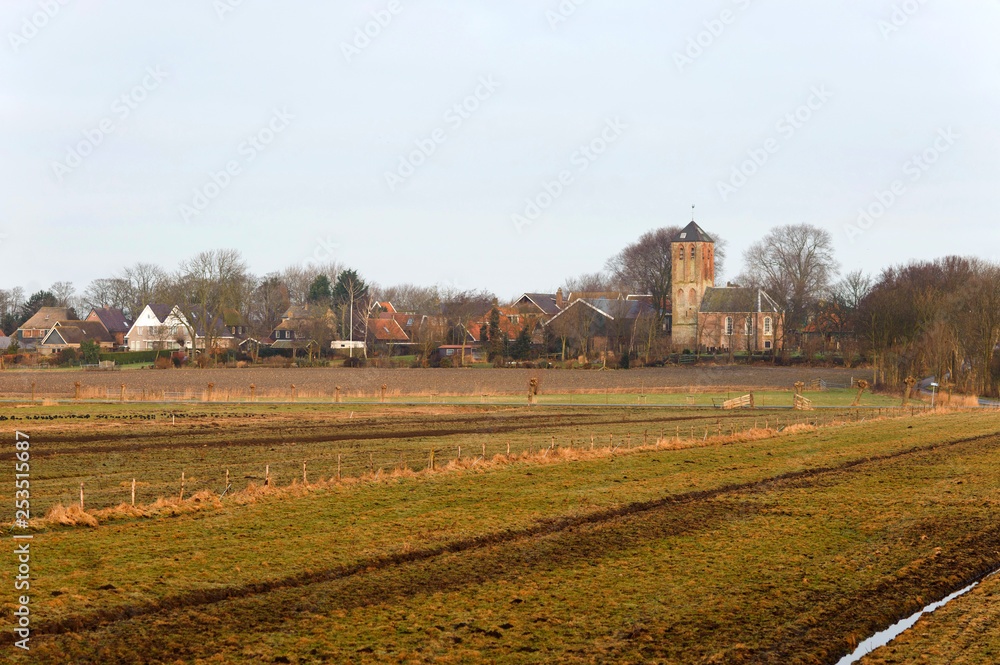 Old traditional church and fields in Hippolytushoef at spring, Hollands Kroon, Netherlands. Old traditional church and fields in Hippolytushoef at spring, Hollands Kroon, Netherlands.