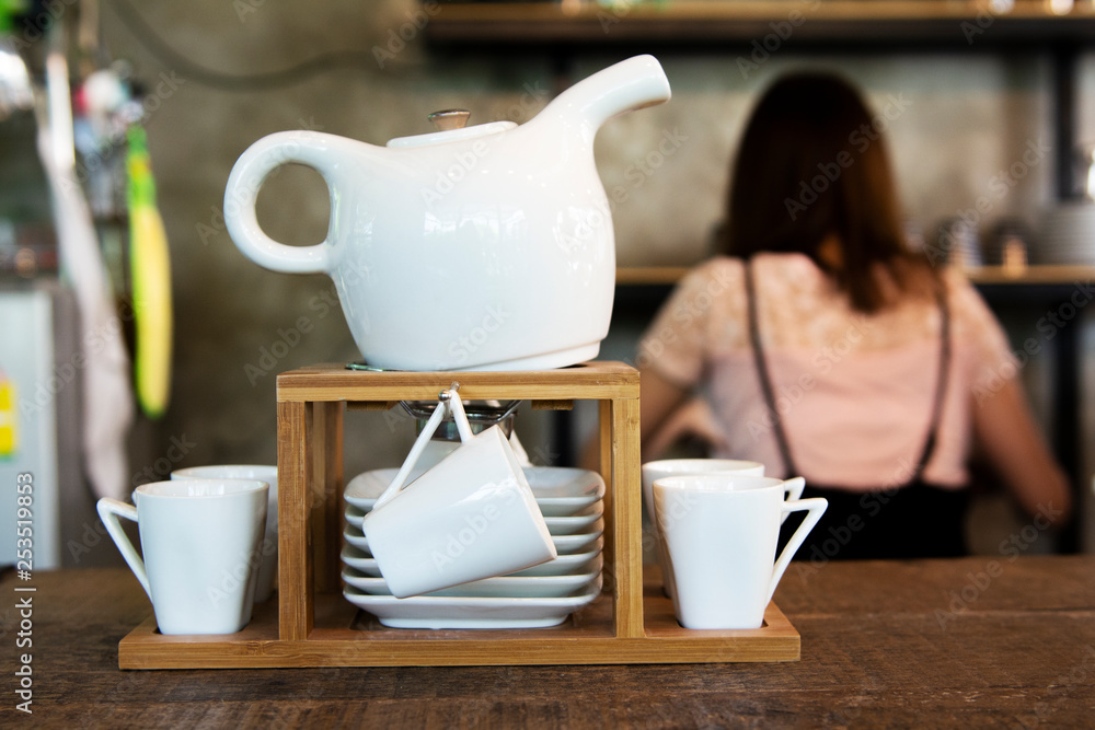 Set of Modern teapot with tea cups in coffee shop background Stock Photo |  Adobe Stock