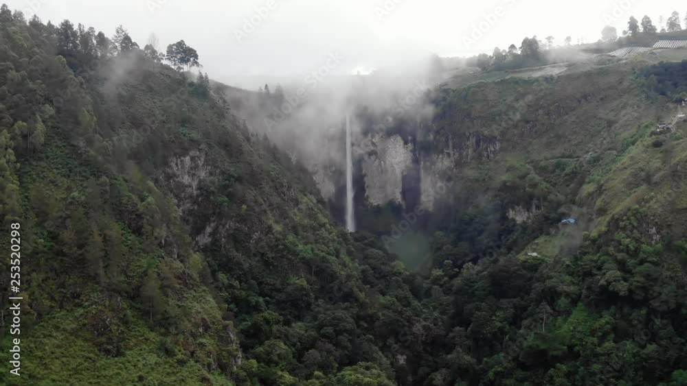 Aerial drone slow pullback shot of Sipiso Piso waterfall in Sumatra, Indonesia. Aerial drone slow pullback shot of Sipiso Piso waterfall in Sumatra, Indonesia.