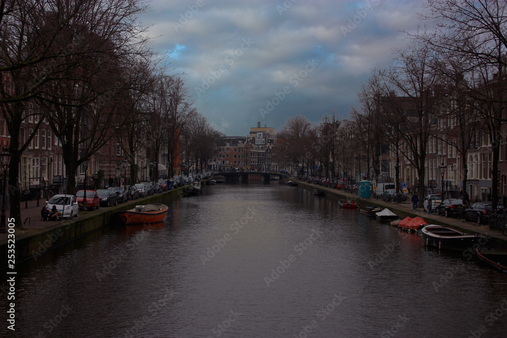the romantic canals of Amsterdam, the traveling boats and its ancient buildings