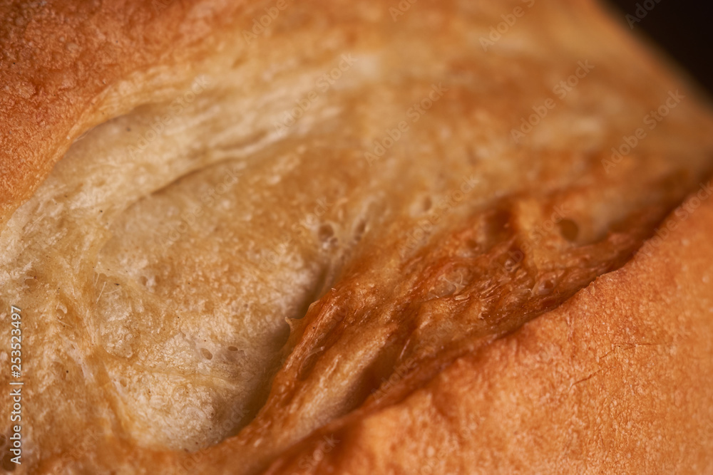 Top view of wholegrain bread on dark ructic wooden background closeup