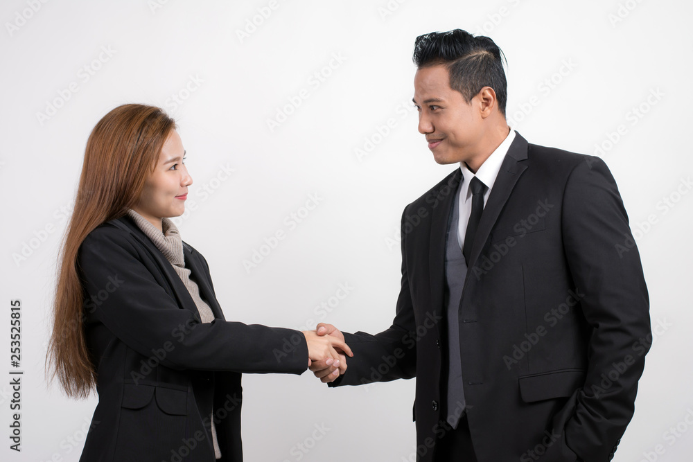 Portrait of pretty Asian businesswoman shaking hands businessman to seal a deal with his partner on a white background