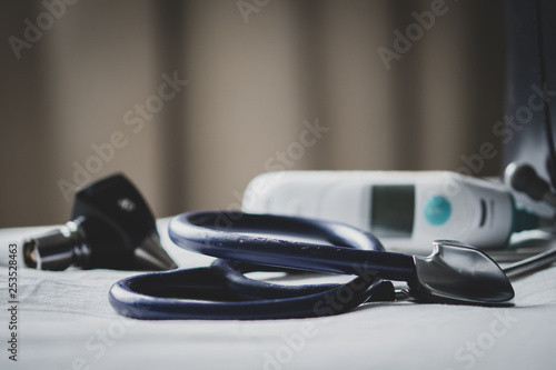 A doctors bag at a clinic - showing stethoscope, otoscope and thermometer.