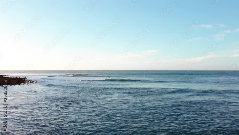 Aerial Drone Shot Flying Over Water With People Surfing Waves In Ocean In Raglan New Zealand Aerial Drone Shot Flying Over Water With People Surfing Waves In Ocean In Raglan New Zealand