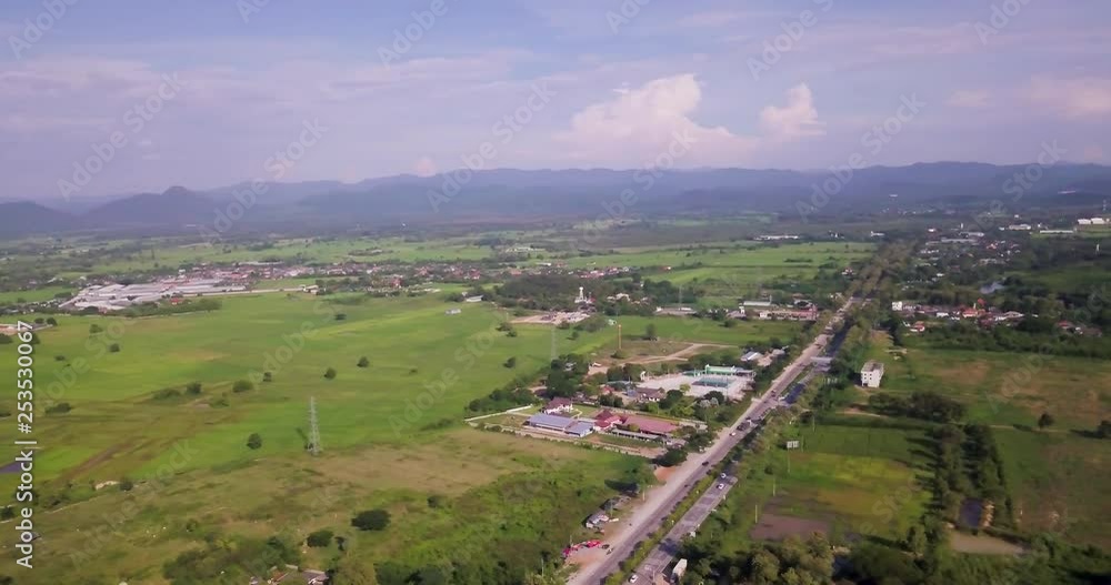 Aerial shot of a busy highways with variety of buildings next to it. Lamphun, Thailand. Aerial shot of a busy highways with variety of buildings next to it. Lamphun, Thailand.