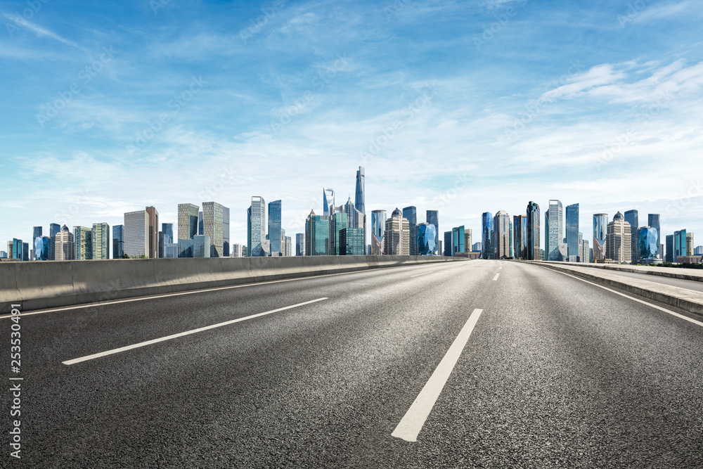Empty asphalt road and panoramic city skyline with buildings in Shanghai Empty asphalt road and panoramic city skyline with buildings in Shanghai