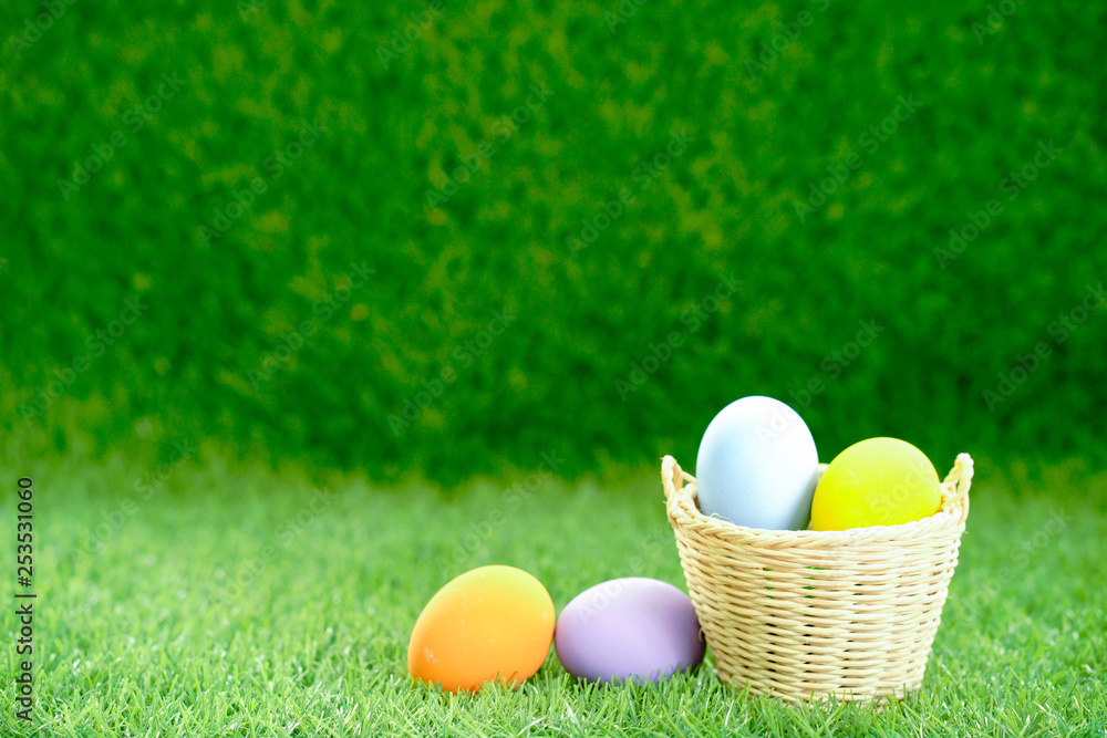 Easter eggs in the basket on green grass Easter eggs in the basket on green grass