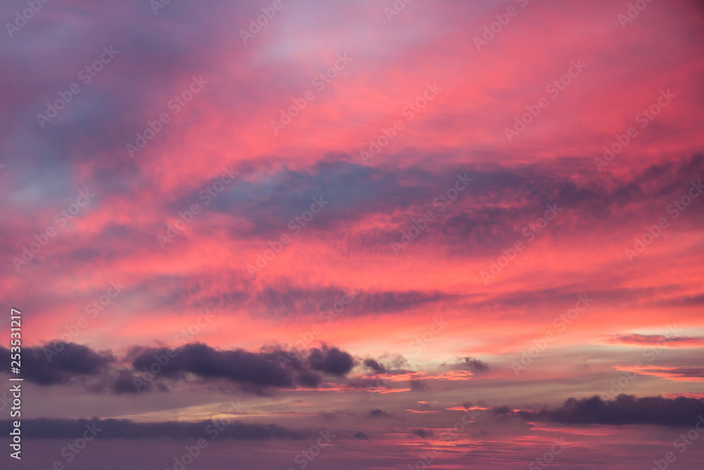 abstract orange background of the sunset sky with wind clouds