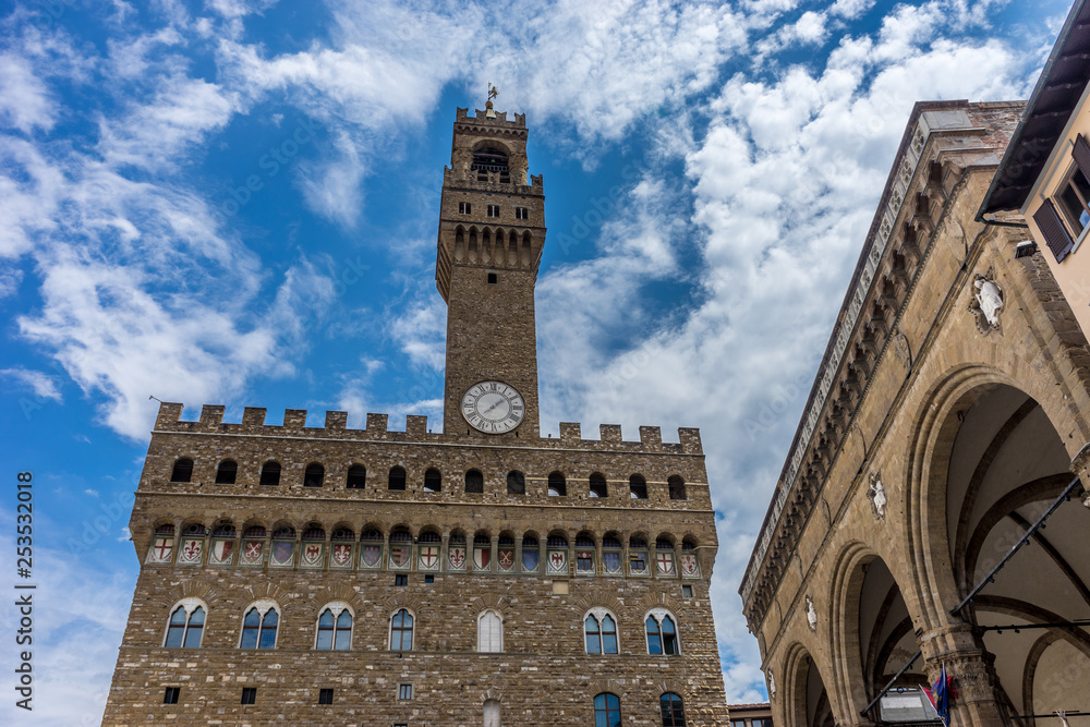 Italy,Florence, Palazzo Vecchio, a large tall tower with a clock on the side of Palazzo Vecchio