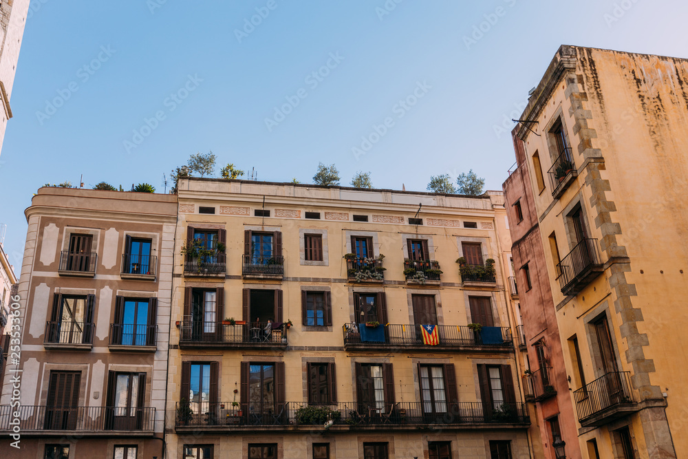 multicolored houses with fenced balconies, barcelona, spain