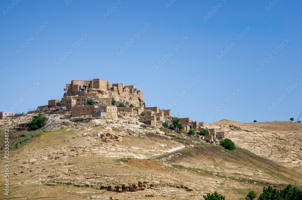 A historical village made of stone houses placed on a mountain at Mardin, Turkey