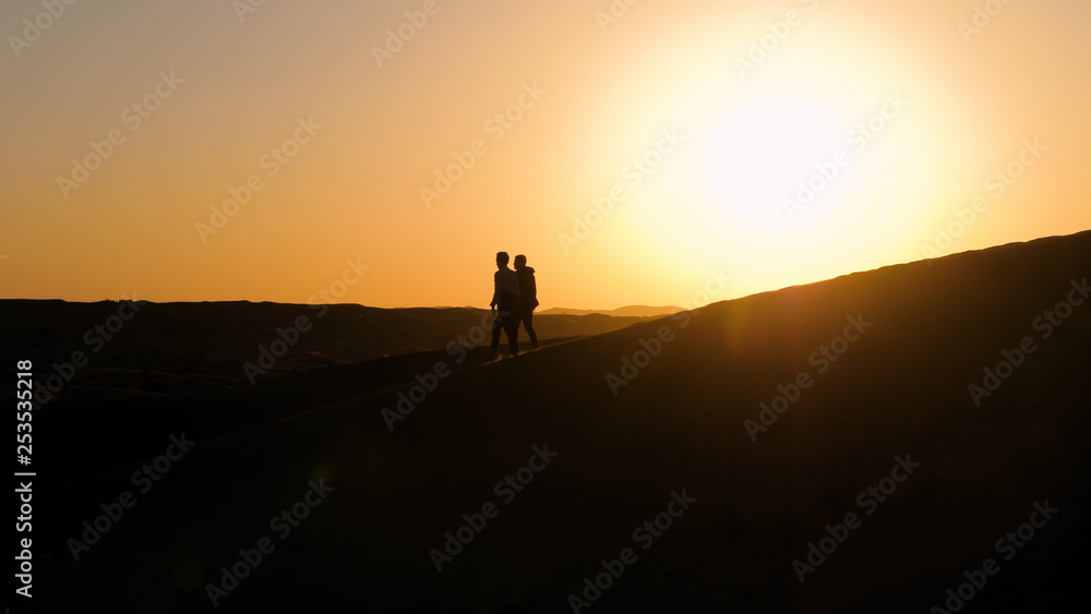 Male silhouettes in desert