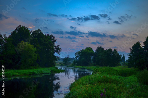 Natural background  misty landscape at dawn by the river in the forest on a summer morning. Republic of Belarus  Borb River. Natural landscape scenery