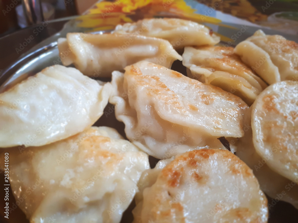 Fried Russian dumplings. A delicious dish on a plate. Ruddy dumplings. Delicious ready and traditional Polish dinner.