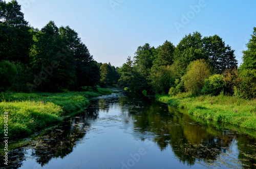 Natural view of the morning light on the lake, from the picturesque bridge, seen in tourist places or scenic spots in the Republic of Belarus on the Beaver River, with twilight and colorful sky © MaxSafaniuk