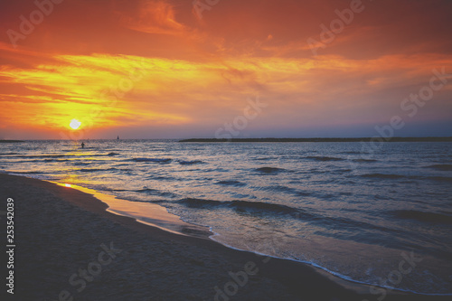 Fototapeta Naklejka Na Ścianę i Meble -  Seashore in the evening. Sunset over the sea. Beautiful beach with dramatic sunset sky