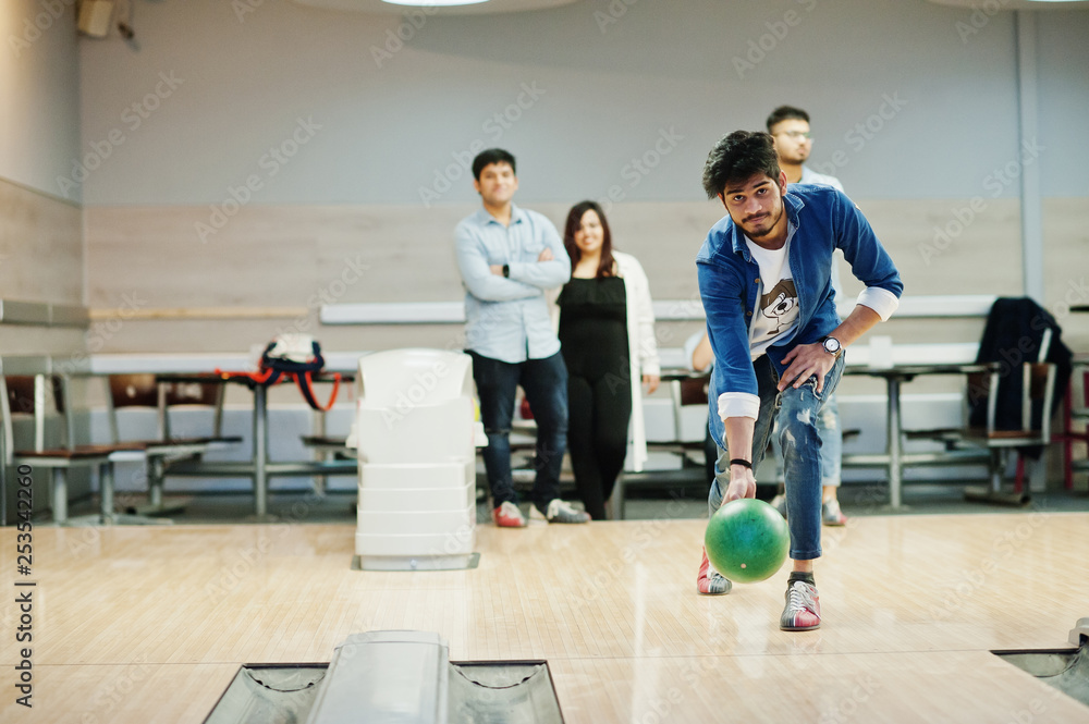 South asian man in jeans shirt standing at bowling alley and throw ball. South asian man in jeans shirt standing at bowling alley and throw ball.