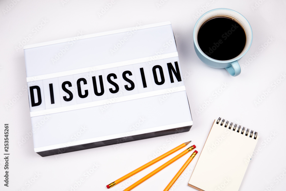 Discussion. Text in lightbox. White desk with stationery Discussion. Text in lightbox. White desk with stationery
