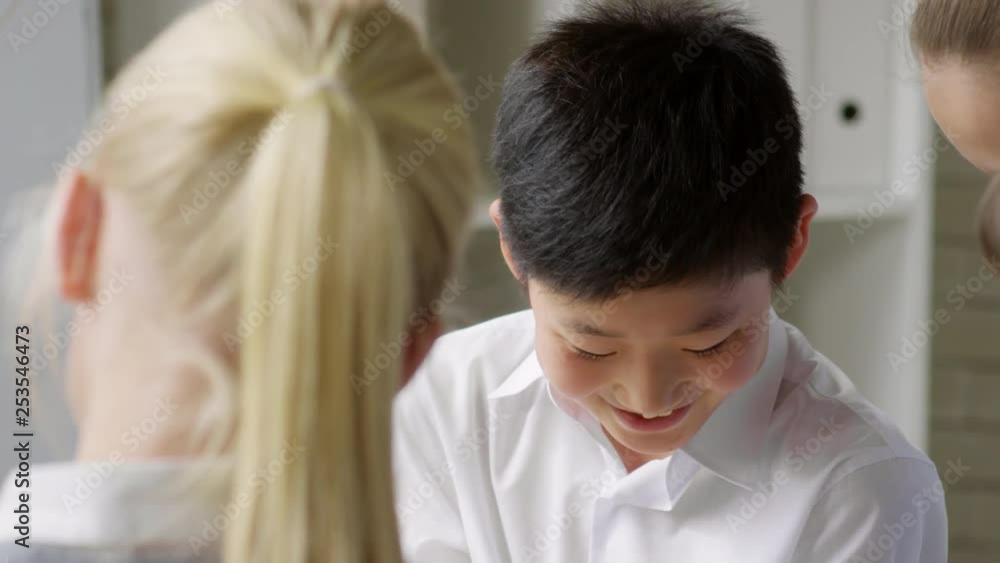 Pan shot of children standing together in office and discussing new strategy Pan shot of children standing together in office and discussing new strategy