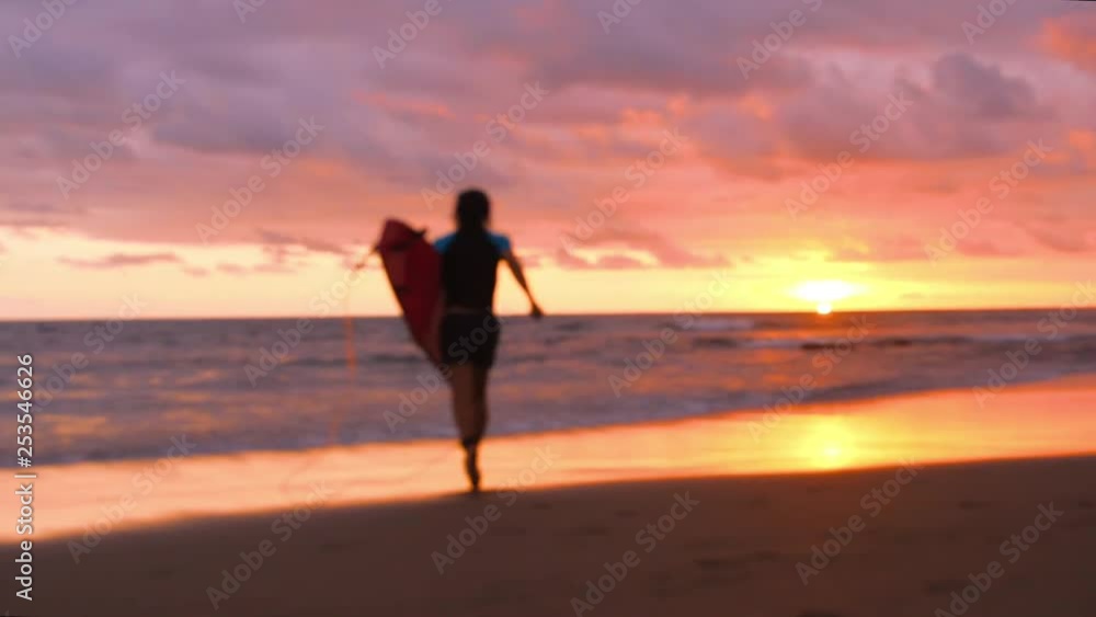 Surfer Man Running on the Beach with Amazing Sunset on Background. HD Slowmotion Summer Carefree Vacation Surfing Activity. Bali, Indonesia. Surfer Man Running on the Beach with Amazing Sunset on Background. HD Slowmotion Summer Carefree Vacation Surfing Activity. Bali, Indonesia.