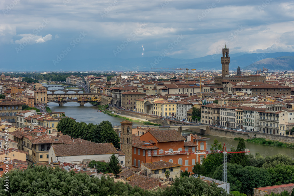 Panaromic view of Florence townscape cityscape viewed from Piazzale Michelangelo (Michelangelo Square) with ponte Vecchio and Palazzo Vecchio with lightning