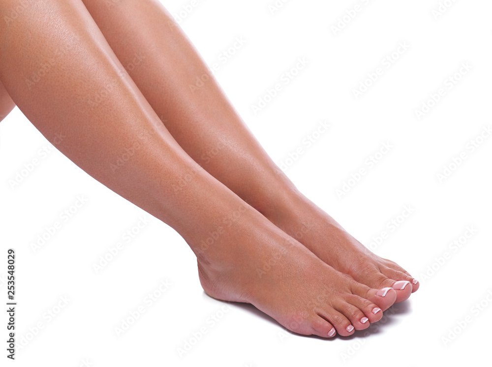 Girl's legs with french pedicure on white background Girl's legs with french pedicure on white background