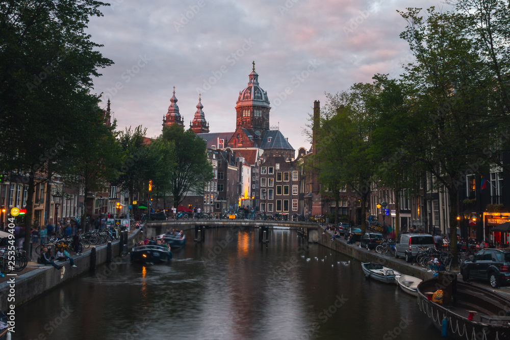 Obraz premium Church of Saint Nicholas dominating the main canal from Red Lights District at the center of Amsterdam, Holland, The Netherlands.