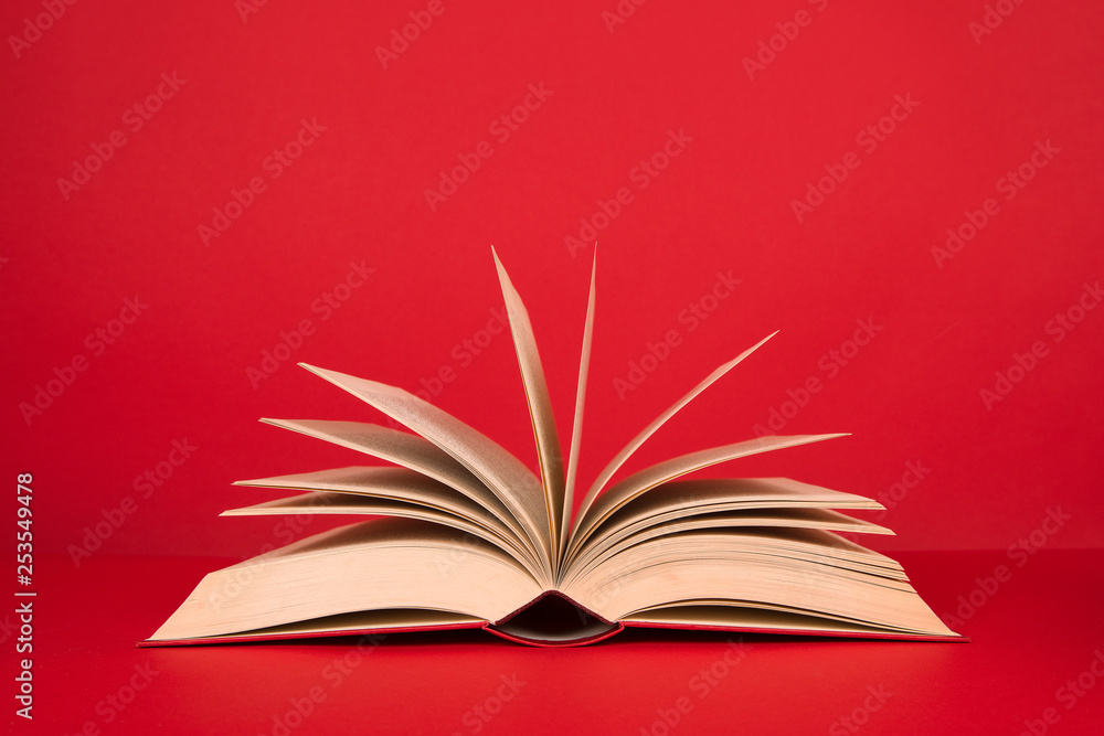 Open book with pages on a red background Open book with pages on a red background