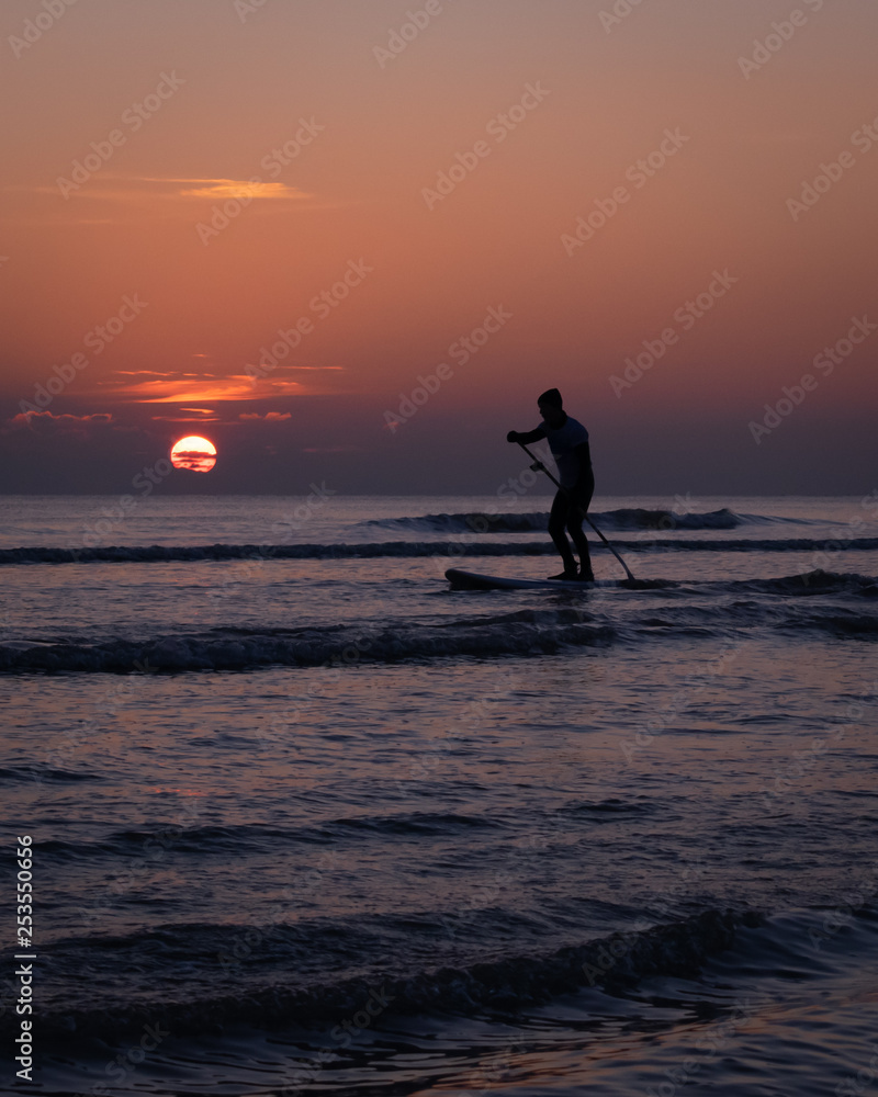 man on board with sunset