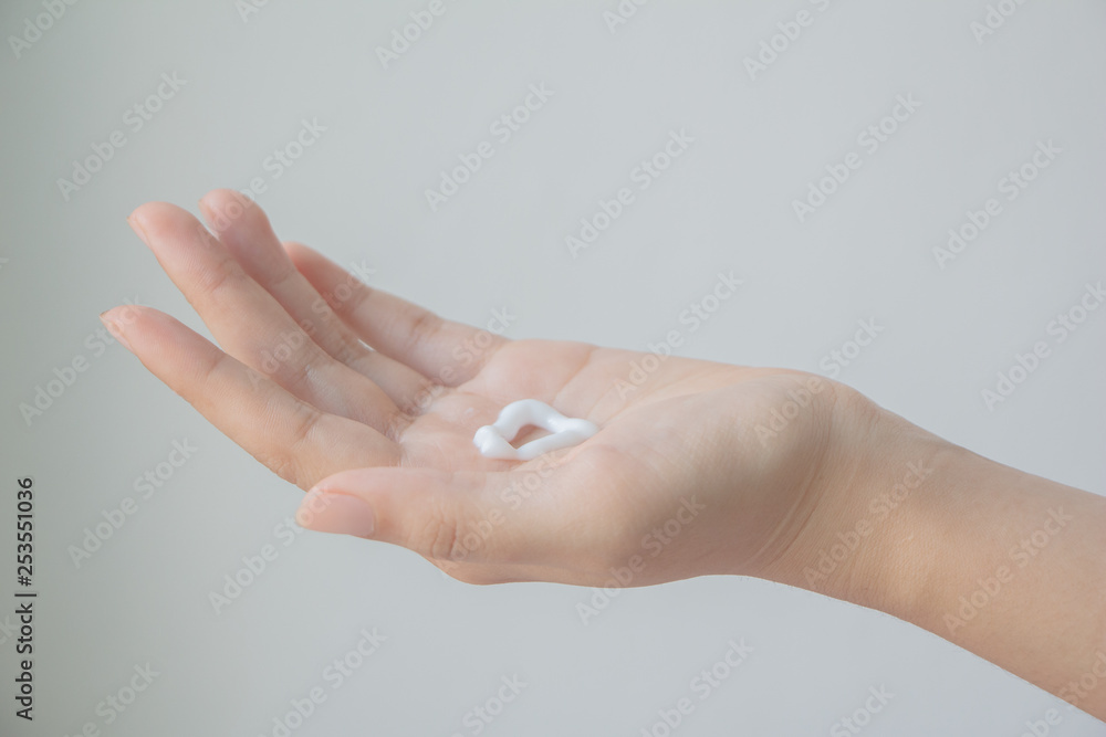 Woman hand with hand cream.
