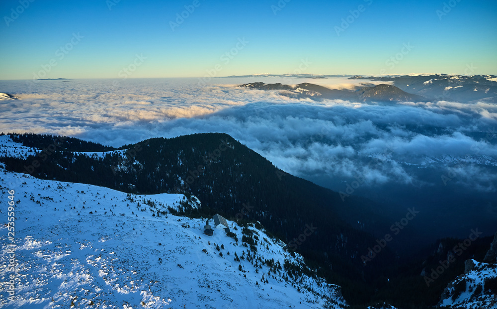 Amazing Landscape view from Ceahlău Mountains witn Sea of clouds in winter season, Aerial winter Landscape in National Park