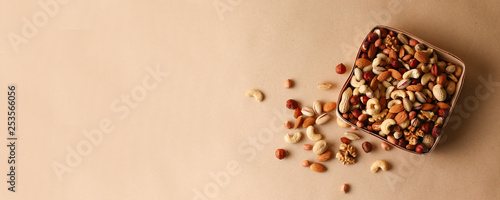 Dried fruits and nuts mix in a wooden bowl. 