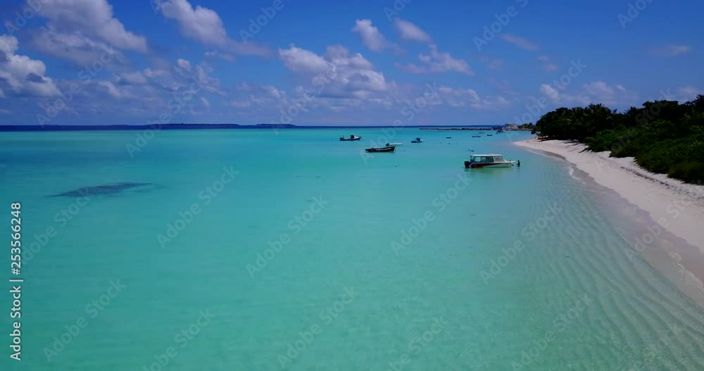 Forward push over brilliant aquamarine ocean, white sand beaches and fisherman walking out to boats in shallow waters. 4k Forward push over brilliant aquamarine ocean, white sand beaches and fisherman walking out to boats in shallow waters. 4k