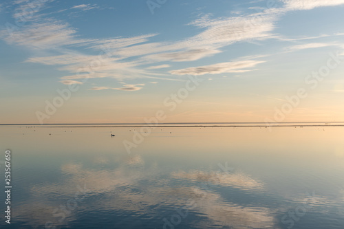 White clouds reflecting in calm water