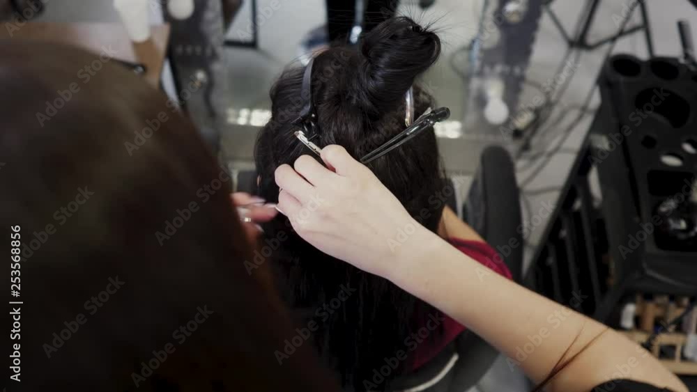 Hairdresser hair extensions brunette girl. Braiding braids for subsequent hair extensions. 4K Hairdresser hair extensions brunette girl. Braiding braids for subsequent hair extensions. 4K