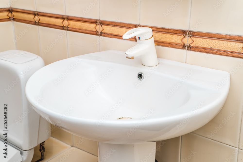 The photo of a sink in a bathroom The photo of a sink in a bathroom