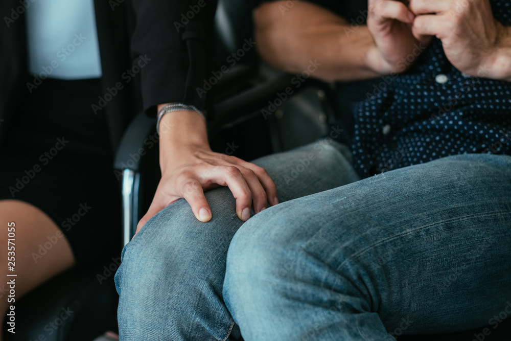 Employer and employee. Harassment behavior. Business woman hand on subordinate man knee.