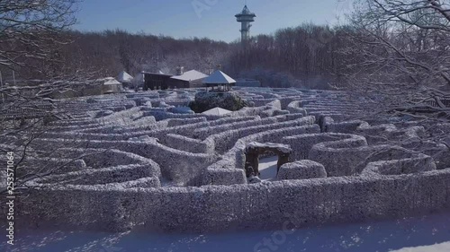 A Beautiful small Labyrinth surroundet by a massive snowy Forest photo