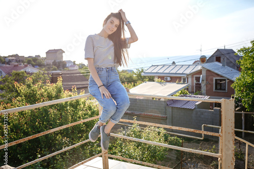 young woman wearing in stripped t-shirt sitting