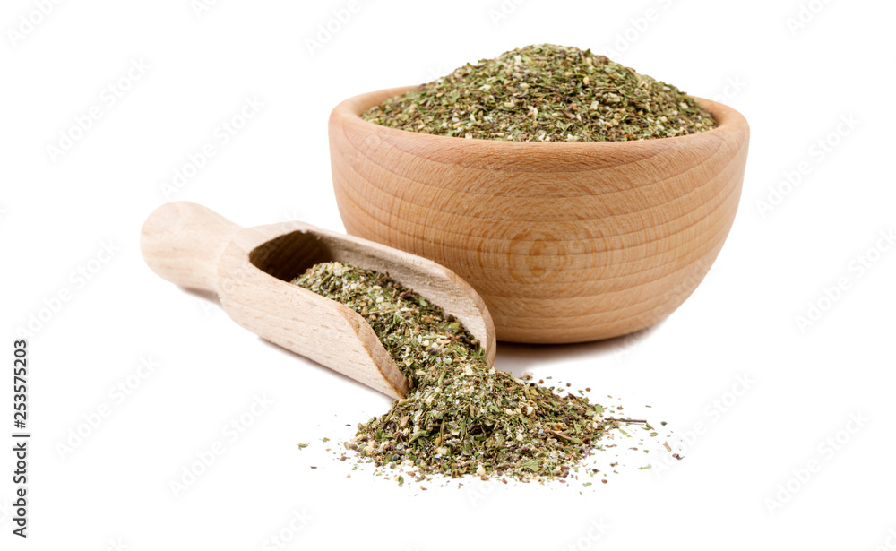 green savory mix or Chubritsa in wooden bowl and scoop isolated on white background. Spices and food ingredients. green savory mix or Chubritsa in wooden bowl and scoop isolated on white background. Spices and food ingredients.
