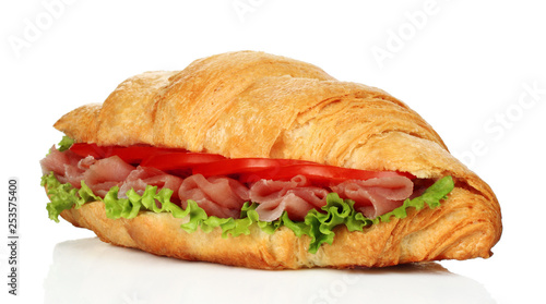 Big croissant with green salad and pork meat