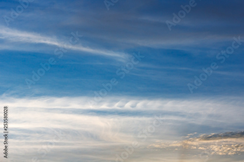 Fotografie Kelvin, Helmholtz instability clouds wavy on blue sky, feathery curls