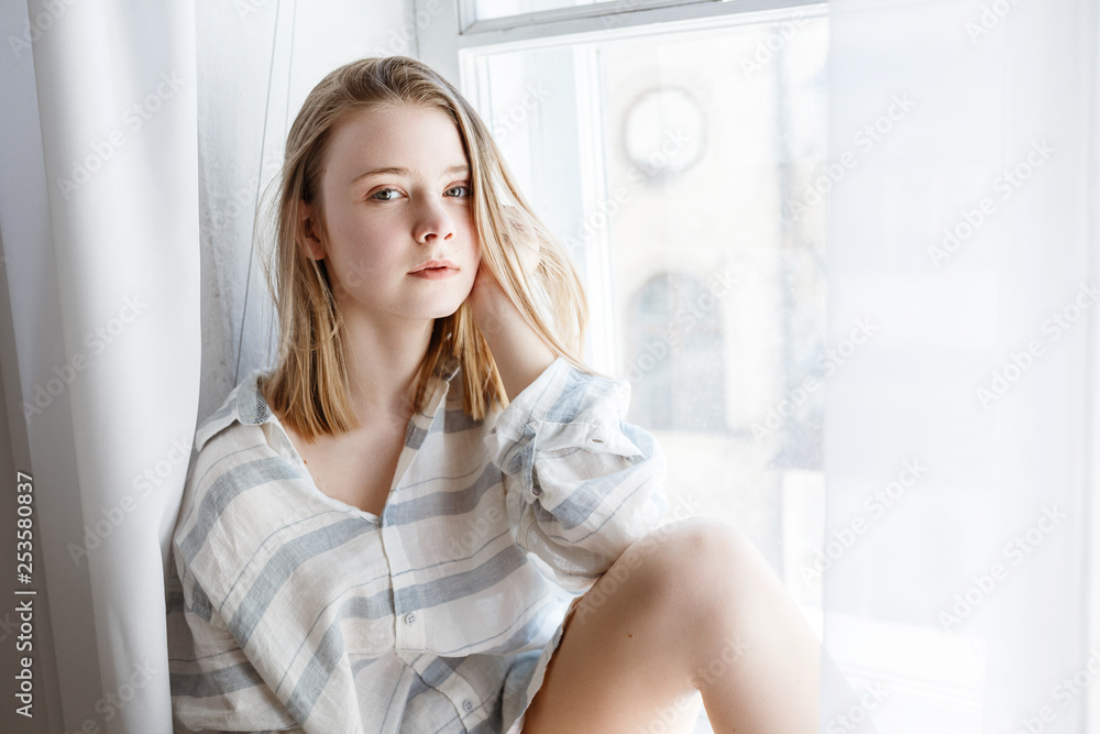 Pretty young woman in modern apartment stretching after wake up Pretty young woman in modern apartment stretching after wake up