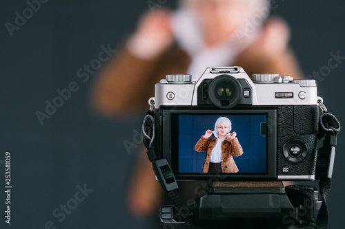 Senior woman style. Confidence and elegance. Aged model posing during studio photo shooting. photo