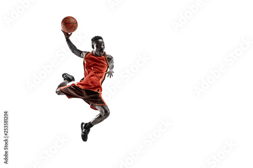 Full length portrait of a basketball player with a ball isolated on white studio background. advertising concept. Fit african anerican athlete jumping with ball. Motion, activity, movement concepts. © master1305