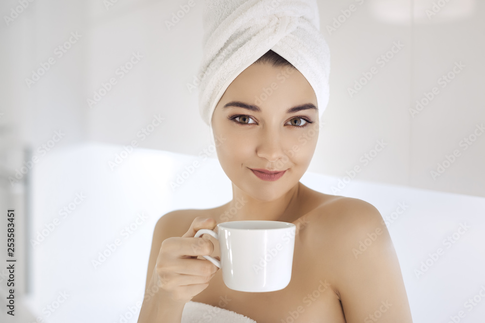Young woman in towel enjoying coffee at home. Young woman in towel enjoying coffee at home.