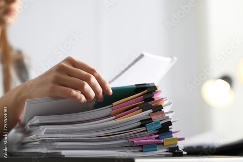 Office employee working with documents at table, closeup photo