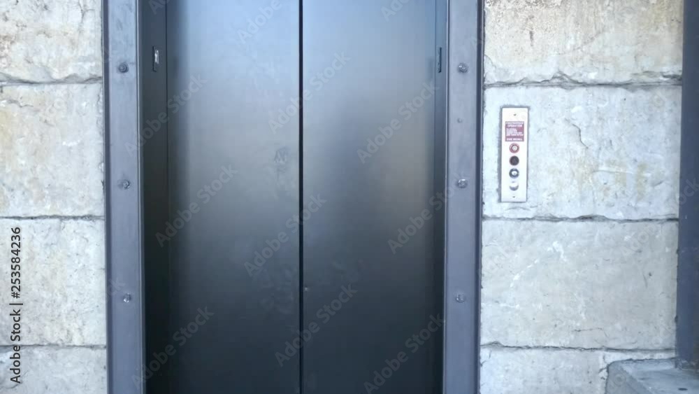 Doors opening and closing on carpark elevator with camera zooming in Doors opening and closing on carpark elevator with camera zooming in