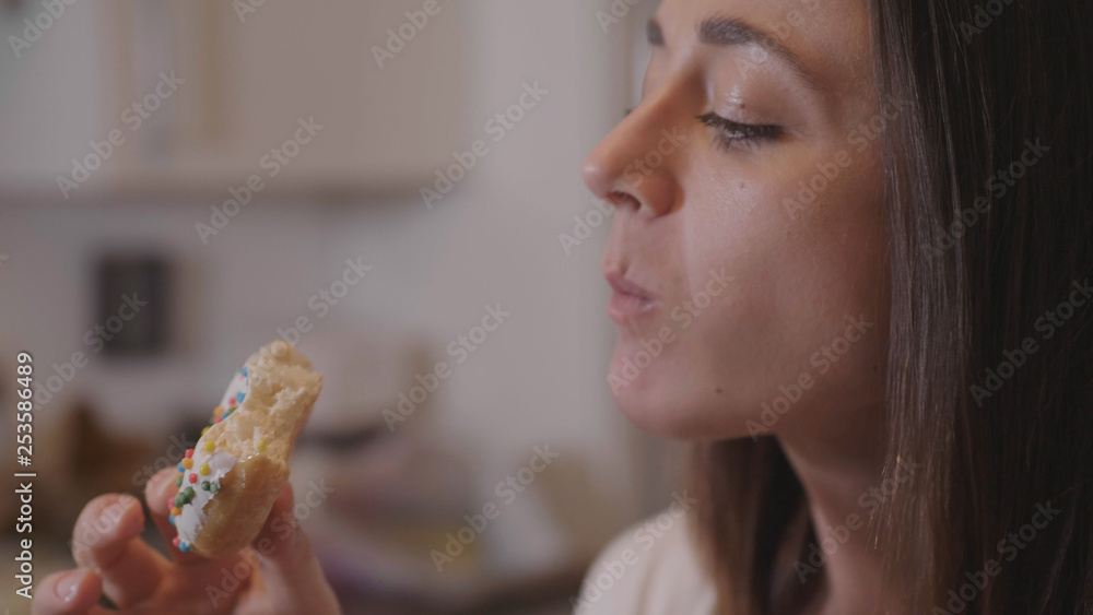 Young woman eats sweet sugar doughnuts Young woman eats sweet sugar doughnuts