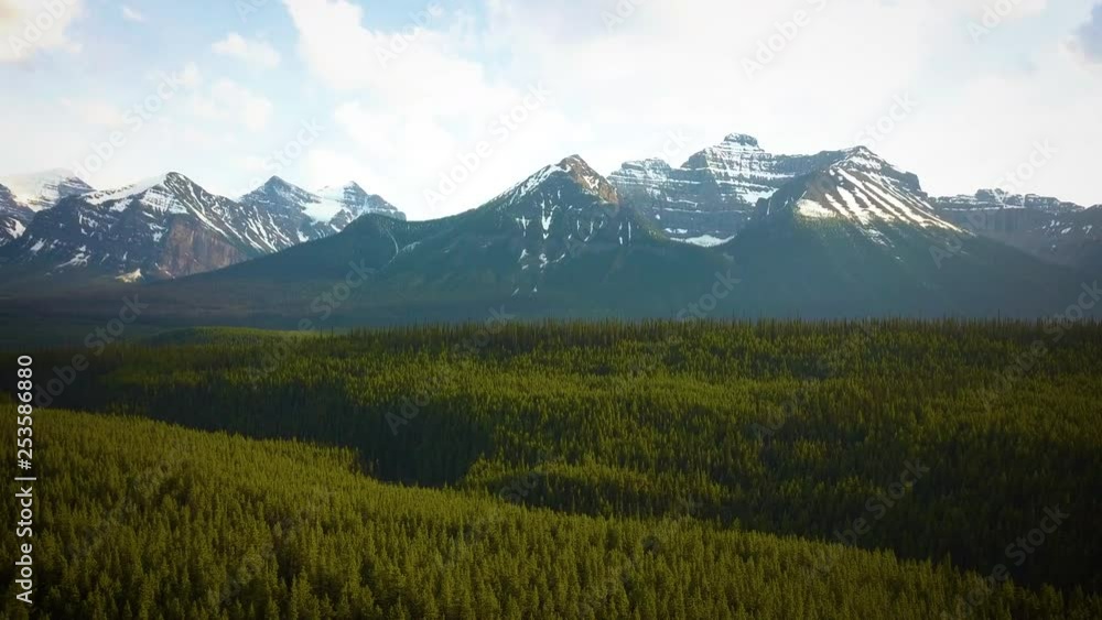Snowy mountain peaks in a vast forest wilderness. Snowy mountain peaks in a vast forest wilderness.